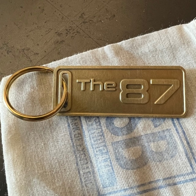 The "THE" Edition brass keychain. 1973 - 1991 Year/Design The 87