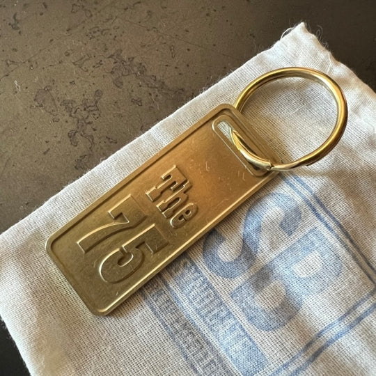 The "THE" Edition brass keychain. 1973 - 1991 Year/Design The 75