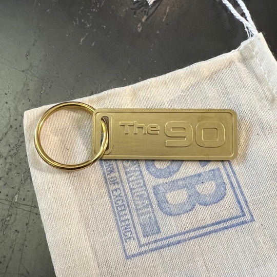 The "THE" Edition brass keychain. 1973 - 1991 Year/Design The 90