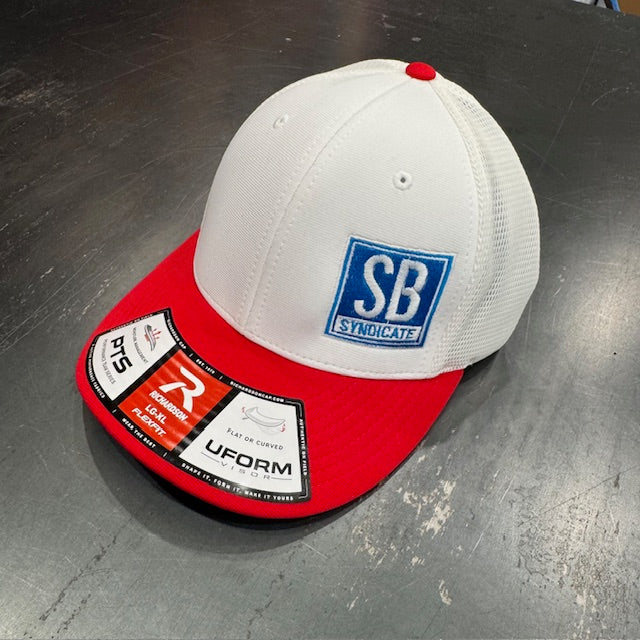 White and red cap with 'SB Syndicate' logo on a metallic surface